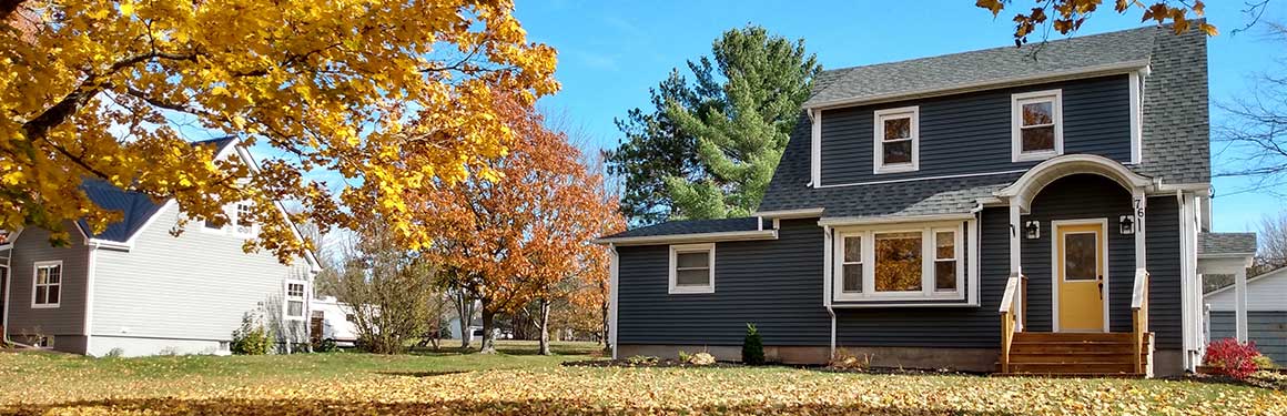 House in fall with leaves in yard